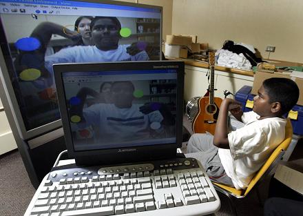 Patient Kajan playing with virtual instrument. (Bloorview MacMillan - Photographer - Mike Cassese)