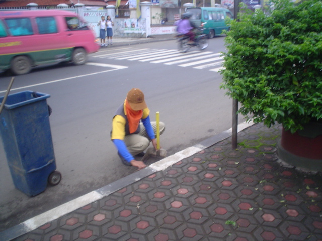 Sujana is cleaning the road.