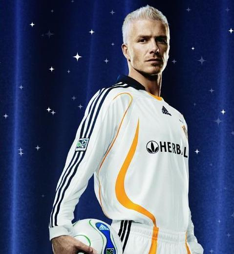 English soccer player David Beckham holds up his new jersey as he is  introduced as the newest member of the Los Angeles Galaxy soccer team in  Carson, California on July 13, 2007. (