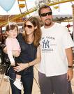 This picture is Adam Sandler, his wife and baby. (google)