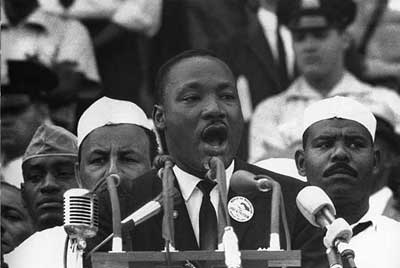 Martin Luther King Jr. making a speech (http://www.downtownpet.com/blog/uploaded_images/martin-luther-king-jr-797580.jpg)