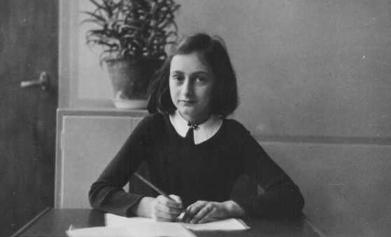 Anne Frank sitting at her desk,age 12, Netherland (www.ushmm.org/Icmedia/photo/image/61/61768.jpg)