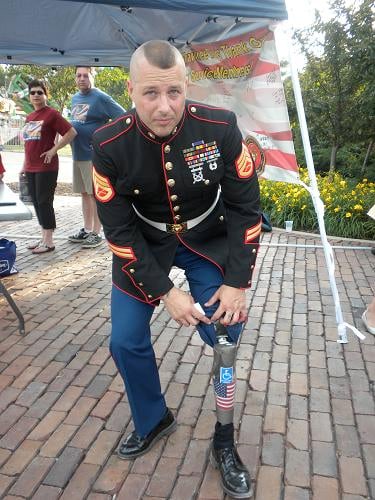 Showing his prosthetic leg (http://orangekite1.wordpress.com/category/american-flag/)