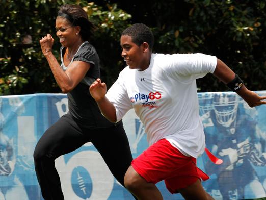 Michelle Obama racing a student. (Politico.com)