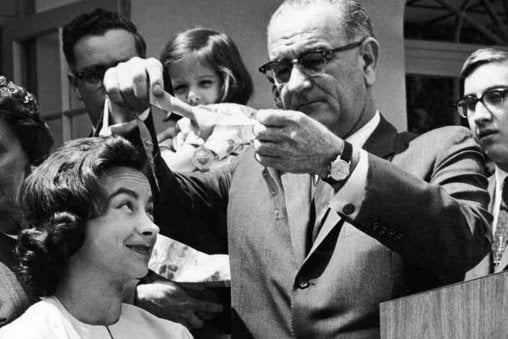 Jennie receiving the Federal Aviation Agency Gold Medal from President Lyndon B. Johnson while surrounded by her family.