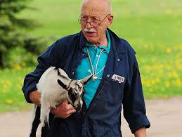 Dr. Pol carrying a goat. (Earth In Transition website )