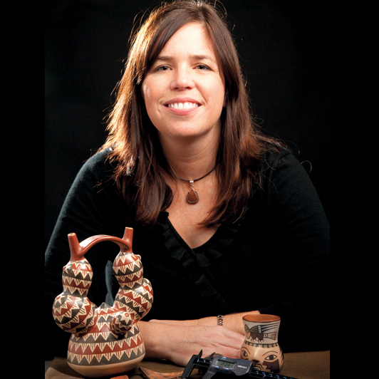 Christina Conlee posing by some artifacts. (https://www.archaeological.org/lecturer/christinaconlee)