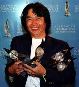 Shigeru Miyamoto in a press shot, in a donkey kong barrel (x-r