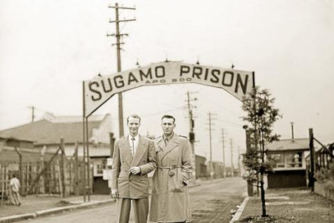 Louis stands in front of his past prison camp. (https://www.awesomestories.com/asset/view/FORGIVEN ())