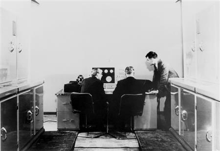 Photo taken of Alan Turing and his colleagues. (http://d3i6fh83elv35t.cloudfront.net/newshour/wp-c (PBS))
